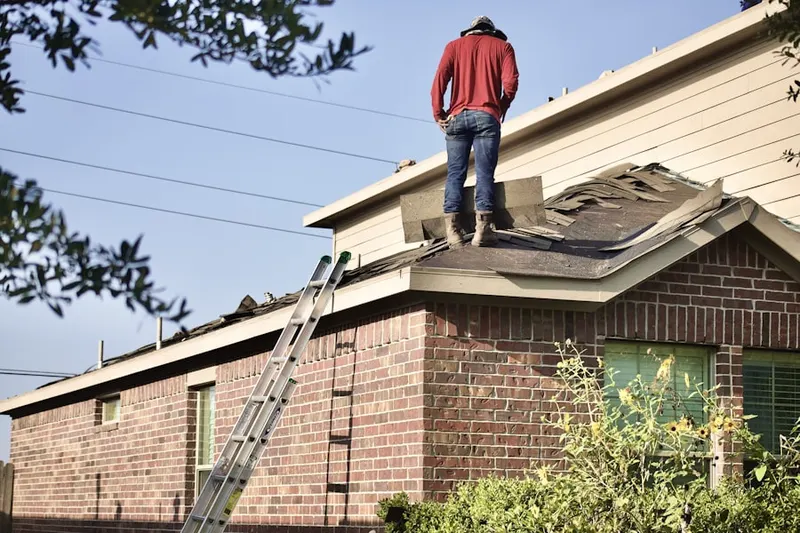 Professional roofer working on a residential roof in Forest Trail